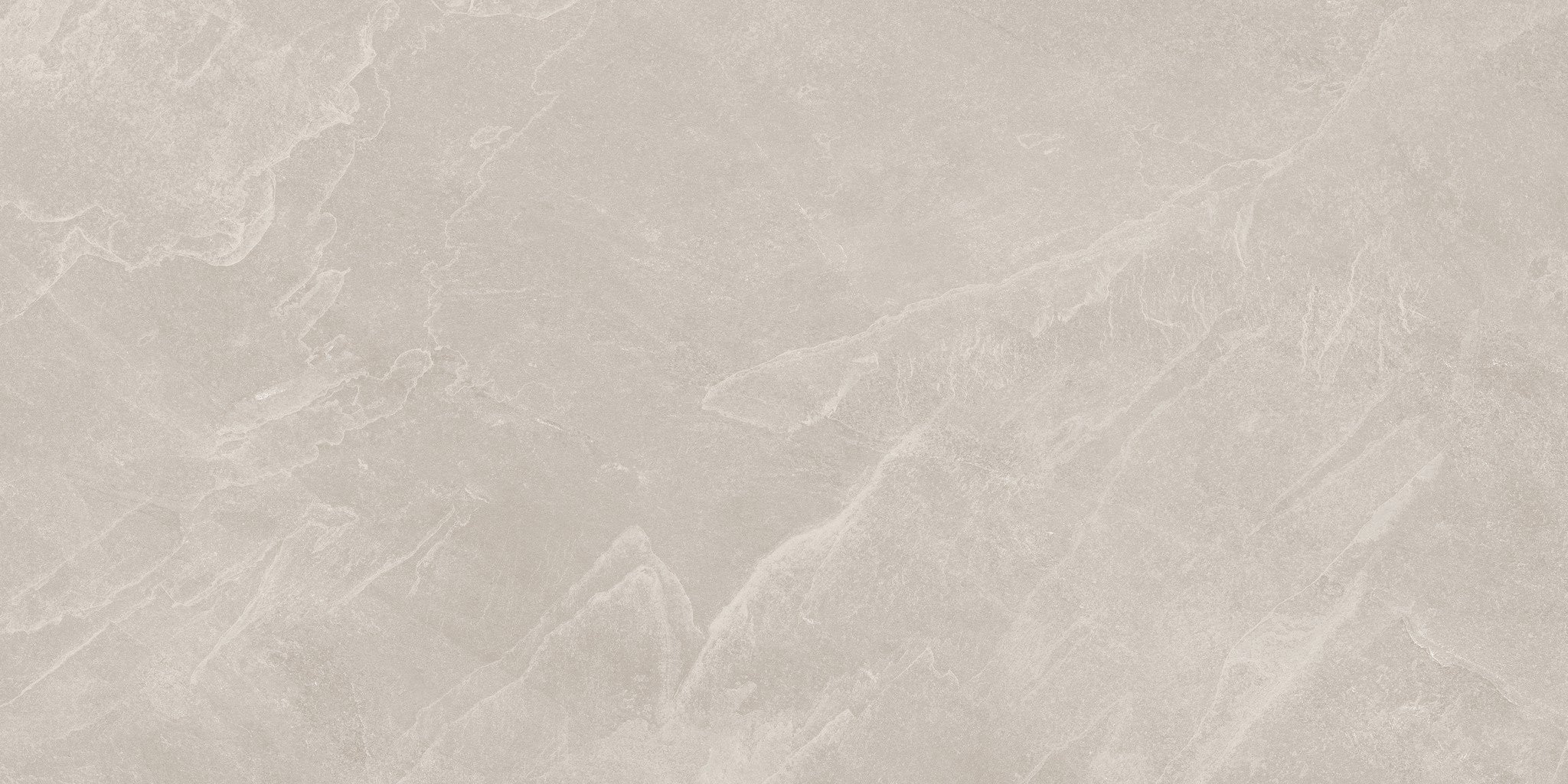 A close-up of a light beige stone or marble surface with soft, natural veining in slightly darker warm gray-beige tones.
